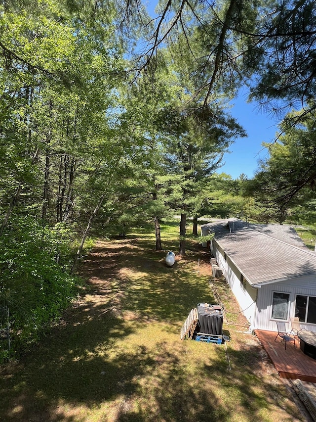 exterior space featuring central air condition unit and a deck