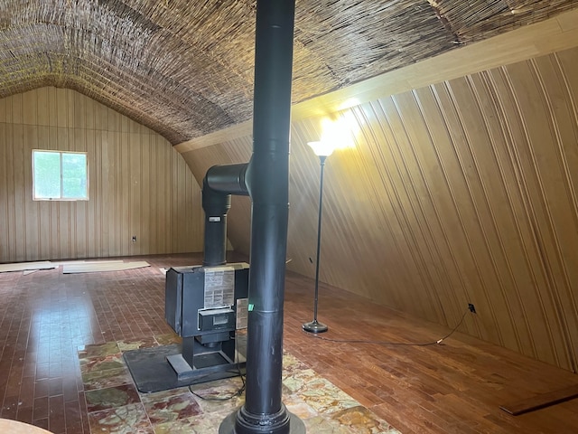 interior details with a wood stove and wood finished floors