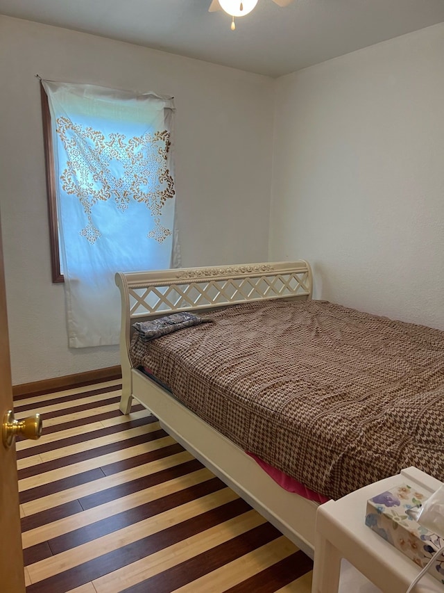 bedroom with a ceiling fan and wood finished floors