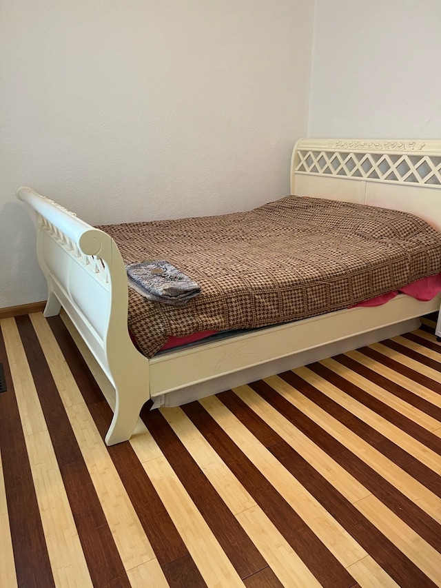 bedroom with wood finished floors