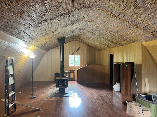 755 S M65 Rd, Twining, MI 48766 - bonus room featuring a wood stove, vaulted ceiling, wooden walls, and hardwood / wood-style floors