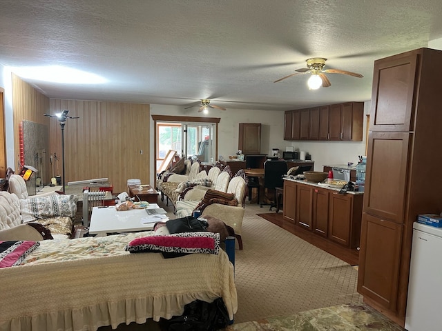 bedroom with ceiling fan and a textured ceiling