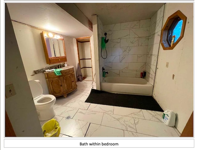 755 S M65 Rd, Twining, MI 48766 - bathroom featuring marble look tiles, vanity, shower / tub combination, and toilet