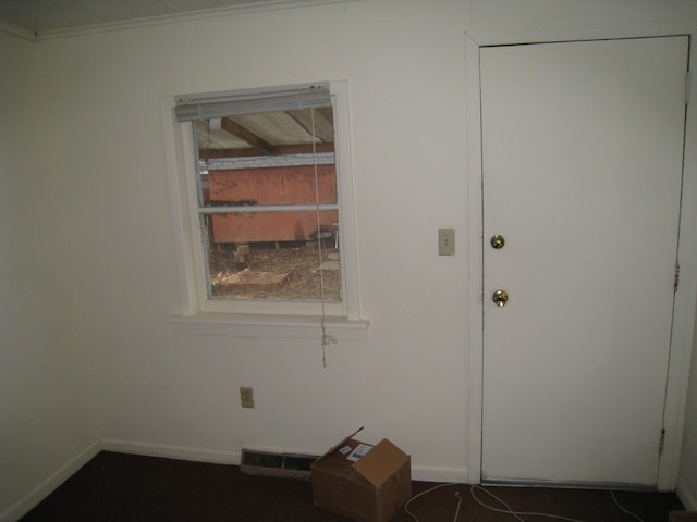 interior space featuring baseboards and visible vents