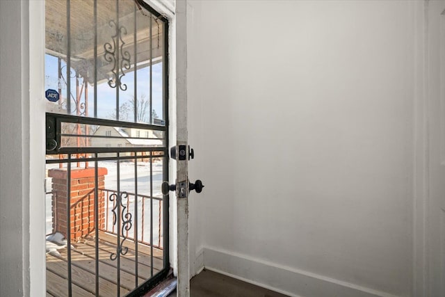 doorway to outside with baseboards