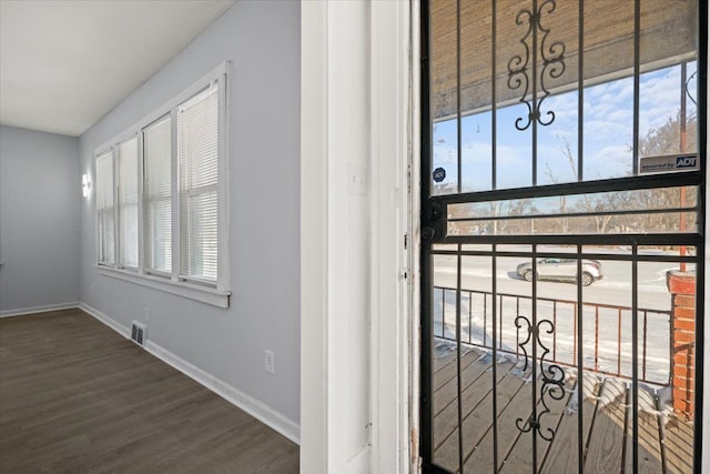 property entrance with a balcony and visible vents