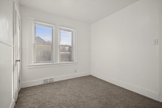 carpeted empty room with baseboards and visible vents