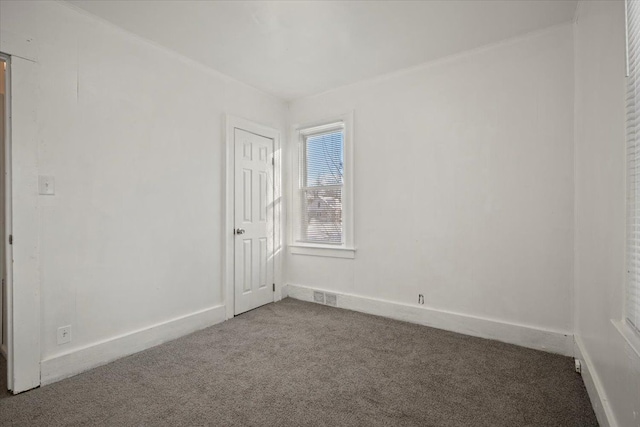 carpeted empty room with visible vents and baseboards