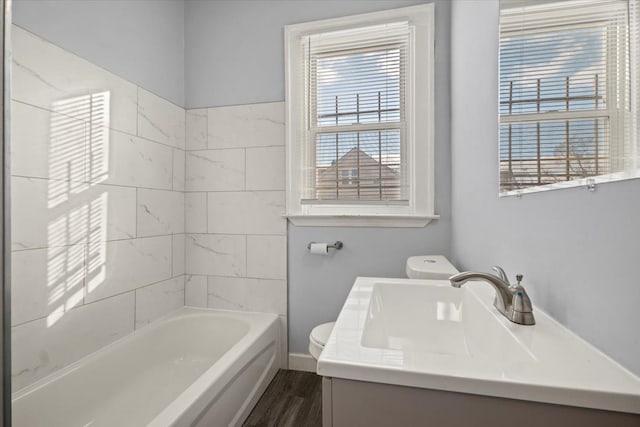 bathroom featuring vanity, wood finished floors, and toilet