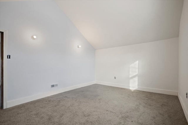 additional living space with lofted ceiling, carpet, visible vents, and baseboards