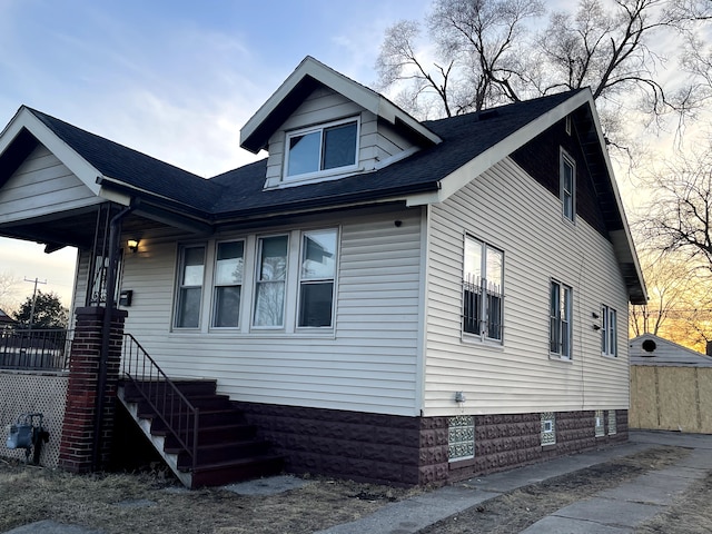 exterior space featuring a shingled roof