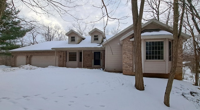 view of front of property with brick siding and an attached garage