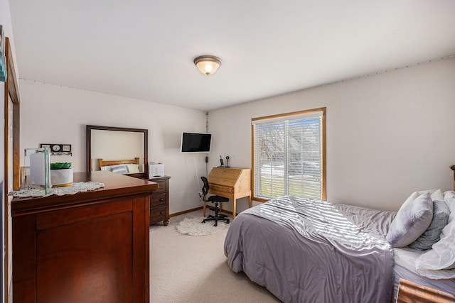 bedroom with light carpet and baseboards