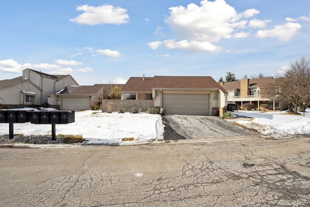 view of front of home featuring driveway, brick siding, and an attached garage