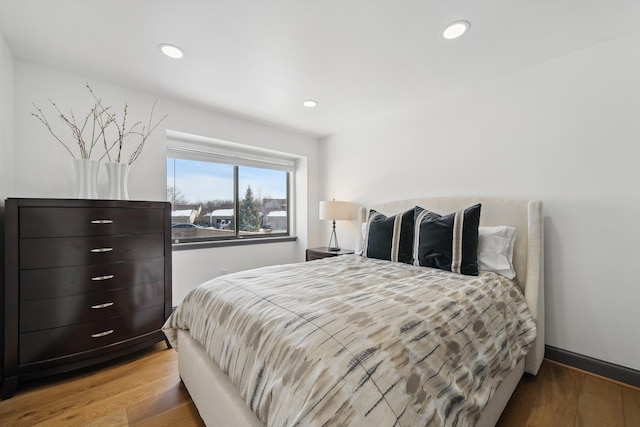 bedroom with recessed lighting, baseboards, and wood finished floors