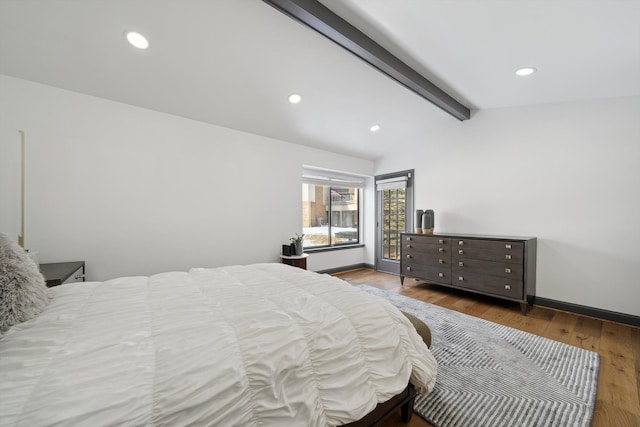 bedroom with lofted ceiling with beams, baseboards, wood finished floors, and recessed lighting