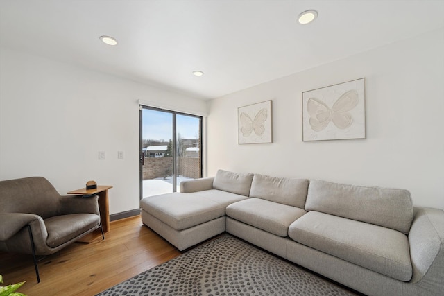 living room with light wood-type flooring and recessed lighting