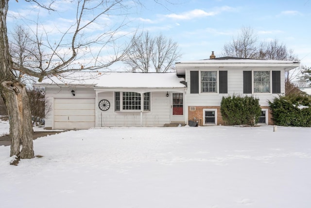 tri-level home with a garage and a chimney