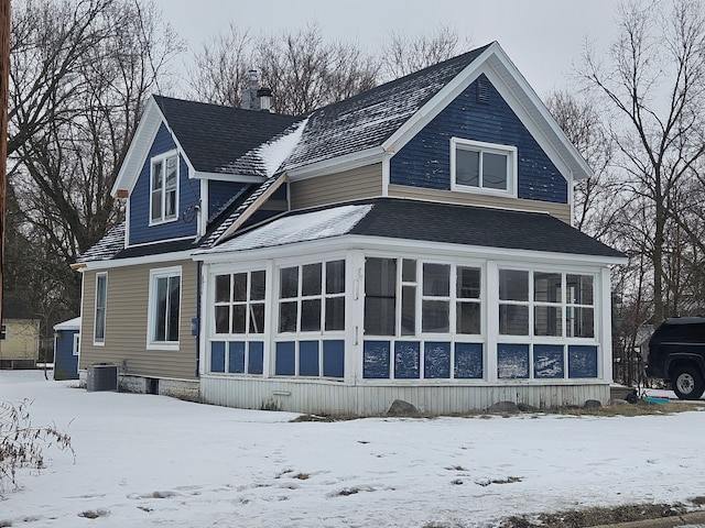 snow covered property featuring cooling unit