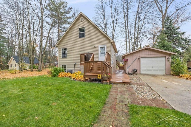 view of front of property with an outbuilding, a deck, a detached garage, concrete driveway, and a front yard