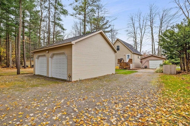 exterior space featuring a detached garage and an outdoor structure