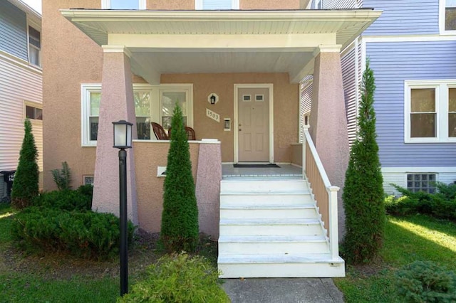 doorway to property with stucco siding