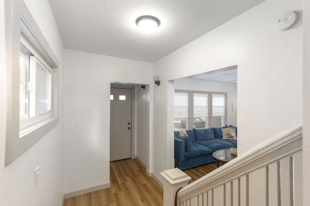 entryway with light wood finished floors and baseboards