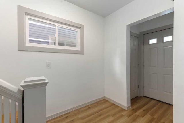 foyer featuring light wood-type flooring and baseboards