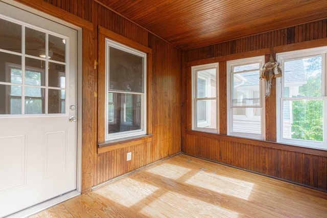 unfurnished sunroom with wooden ceiling and plenty of natural light