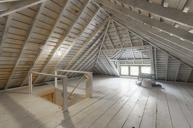 unfinished attic with an upstairs landing