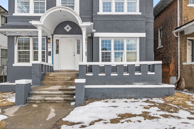 view of snow covered property entrance