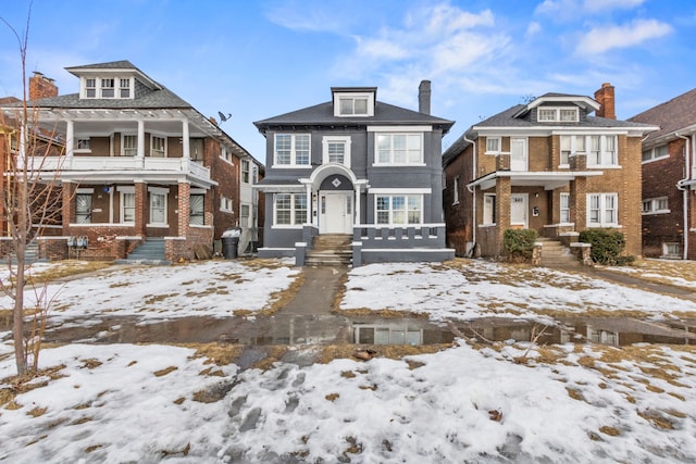 american foursquare style home featuring a residential view and brick siding