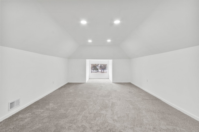 bonus room featuring recessed lighting, light colored carpet, visible vents, vaulted ceiling, and baseboards