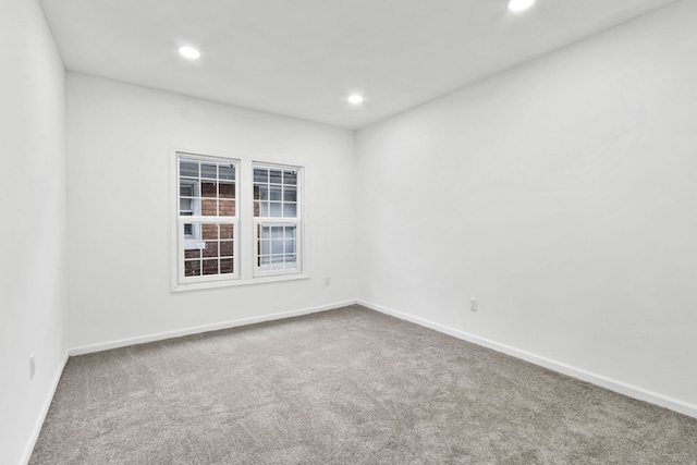 carpeted empty room with baseboards and recessed lighting