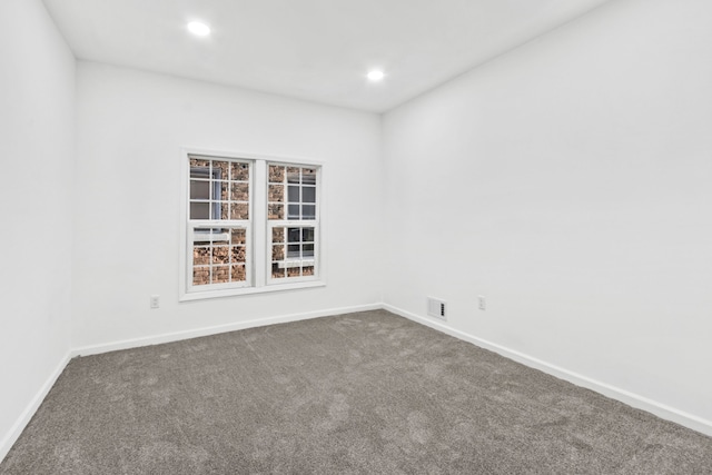 empty room with carpet, visible vents, baseboards, and recessed lighting