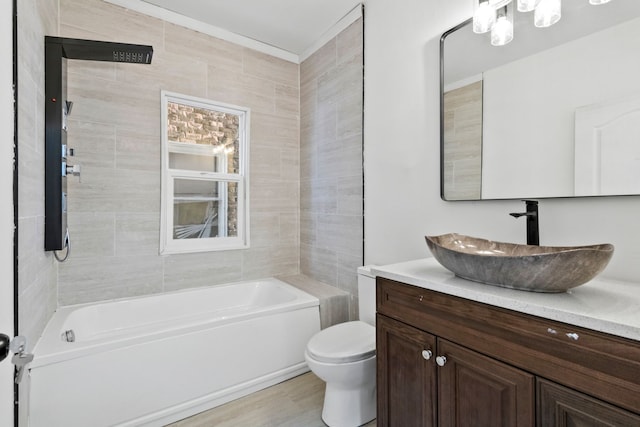 bathroom with wood finished floors, shower / bath combination, vanity, and toilet