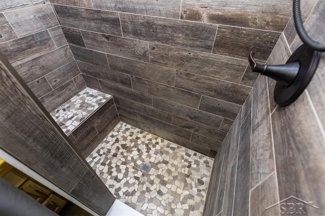 full bath featuring a tile shower