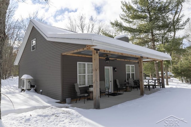 snow covered property featuring a ceiling fan and central AC