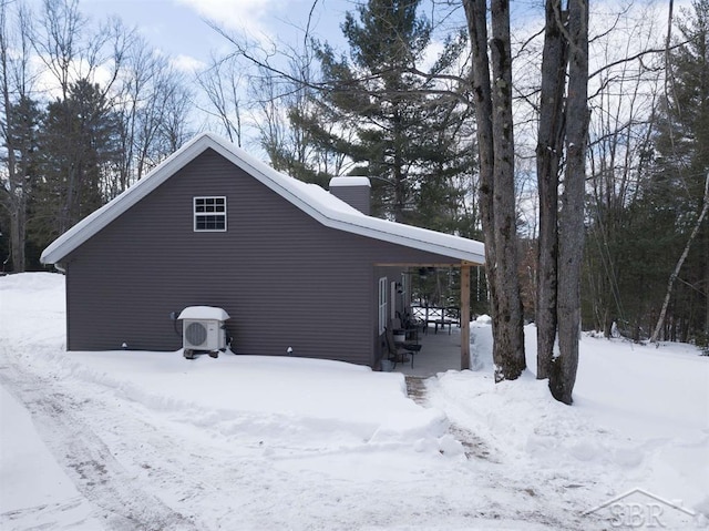 snow covered property featuring a garage