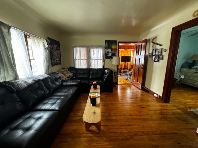 living room with baseboards and wood finished floors