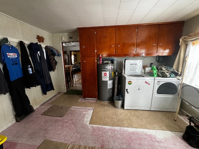 interior space featuring light tile patterned floors, separate washer and dryer, cabinet space, and electric water heater