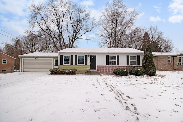 single story home featuring a garage and brick siding