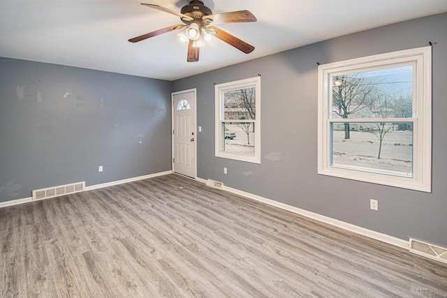 interior space featuring light wood finished floors, visible vents, and baseboards