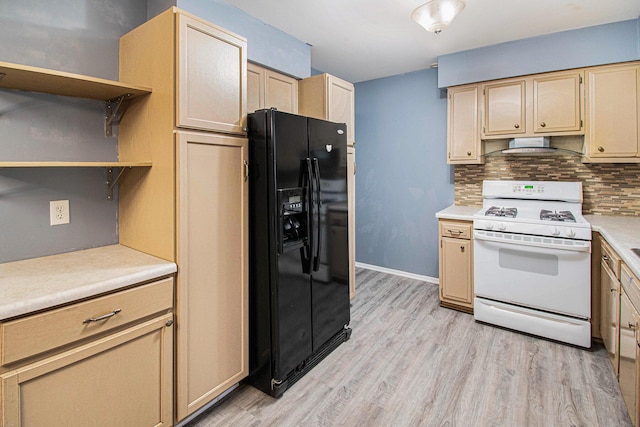 kitchen with white range with gas stovetop, black refrigerator with ice dispenser, light countertops, open shelves, and backsplash