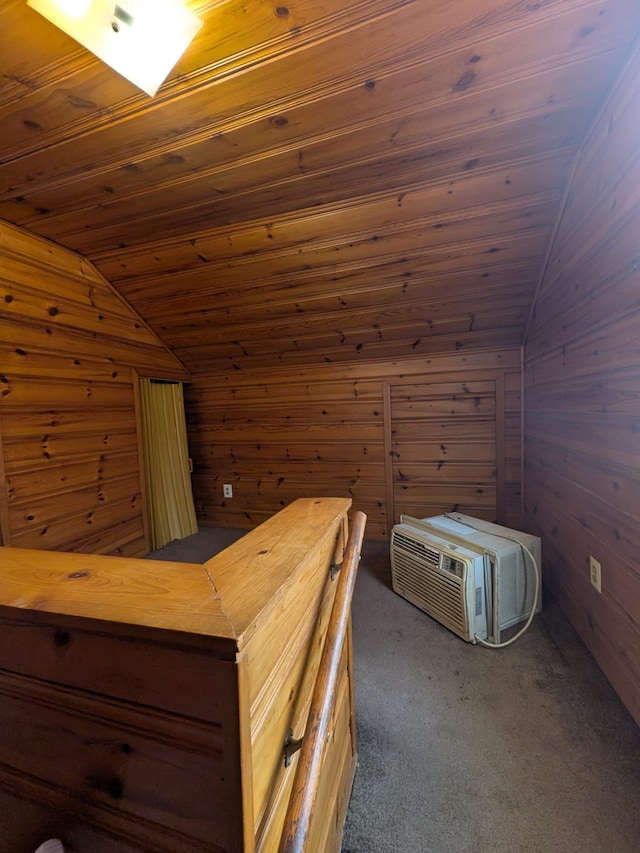 unfurnished bedroom featuring lofted ceiling, wooden ceiling, dark carpet, and wood walls