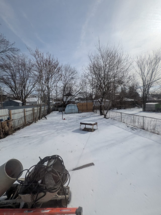 yard covered in snow with fence