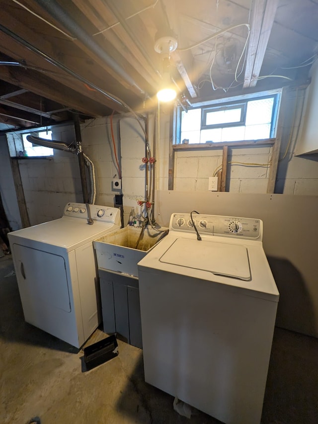 washroom with a sink, laundry area, and washing machine and clothes dryer