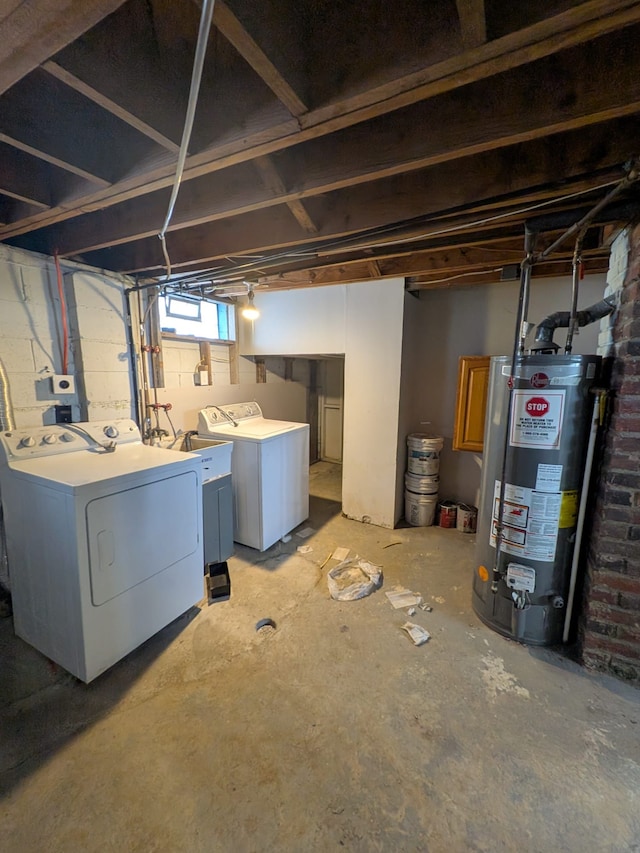 basement with gas water heater and washing machine and clothes dryer