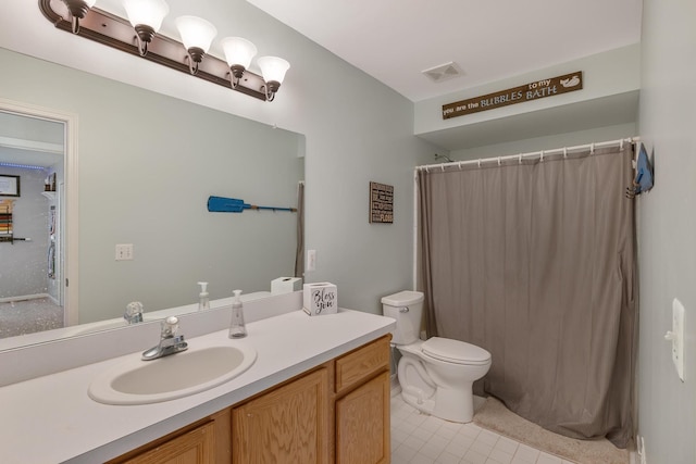 bathroom featuring toilet, vanity, visible vents, and a shower with curtain