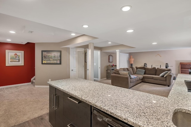 kitchen with open floor plan, recessed lighting, dishwasher, and light stone countertops